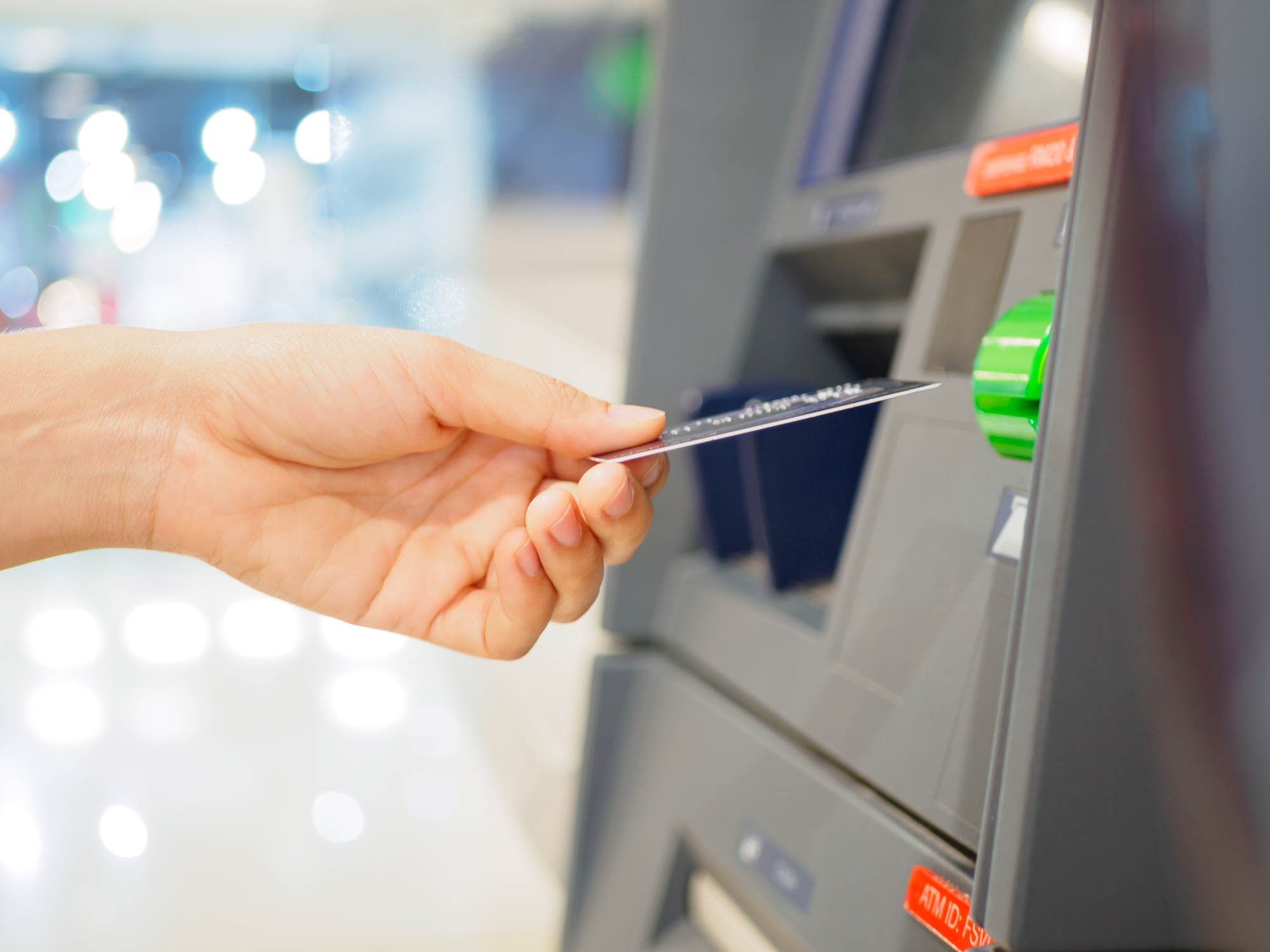 Woman's using an ATM machine
