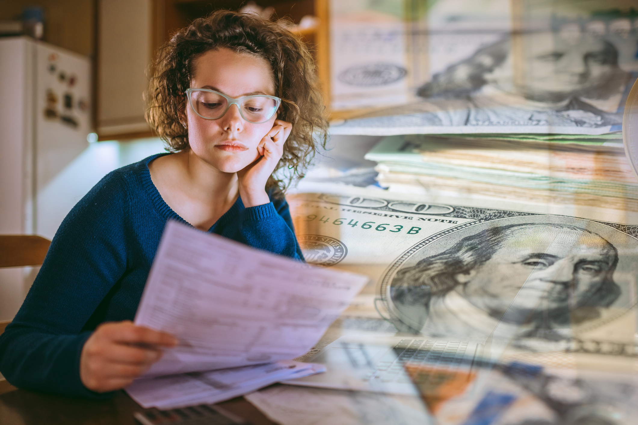 Young woman is looking at bills