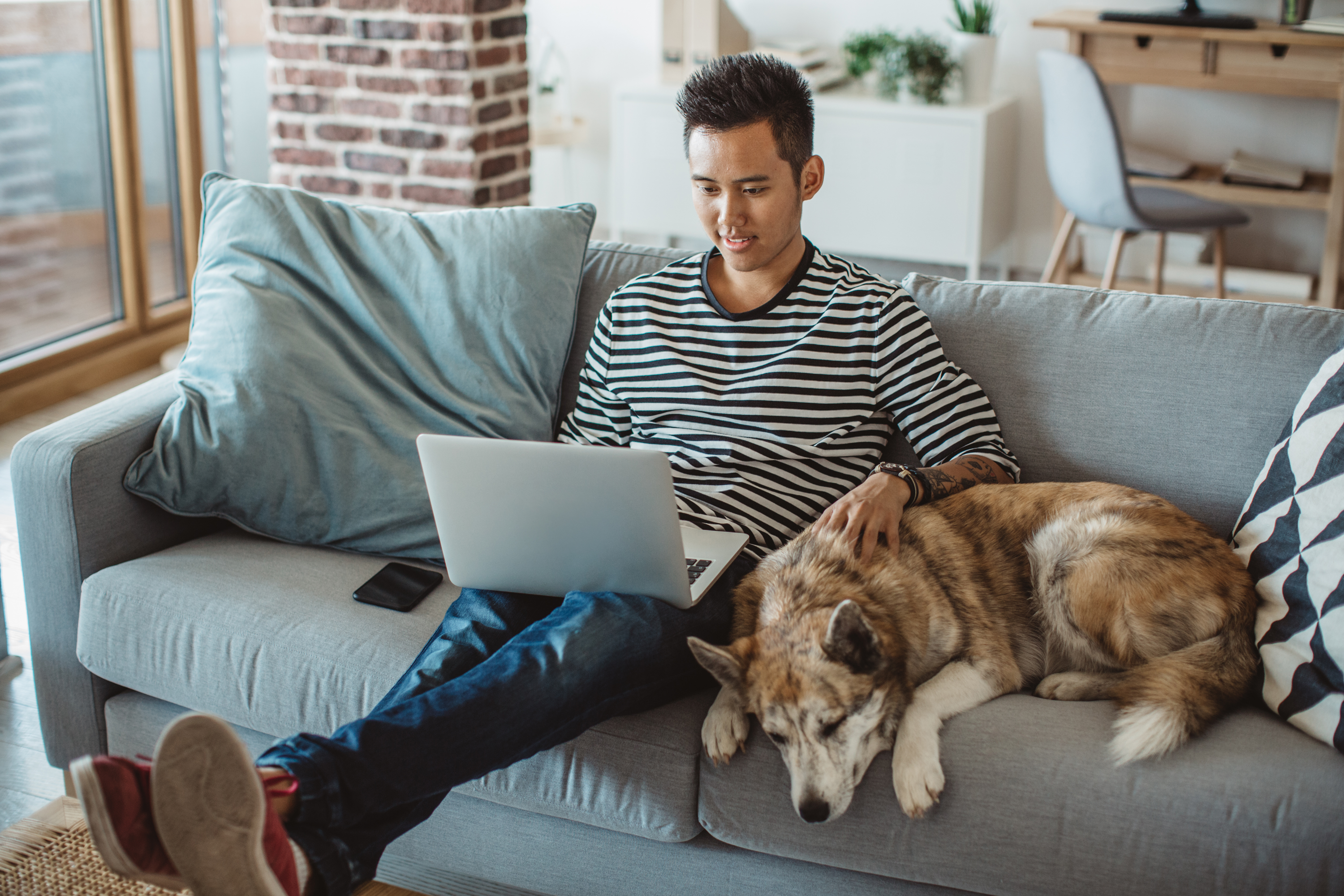 Man sitting on couch with dog