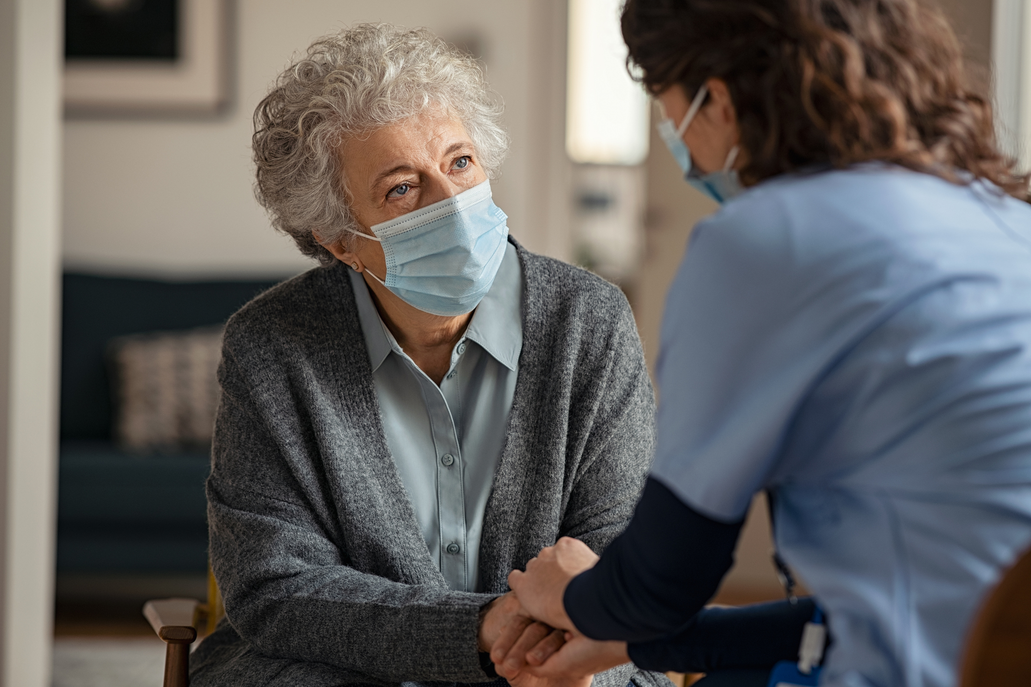Elderly woman talking with a doctor