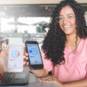 Young women sending money through digital wallet, using wireless technology
