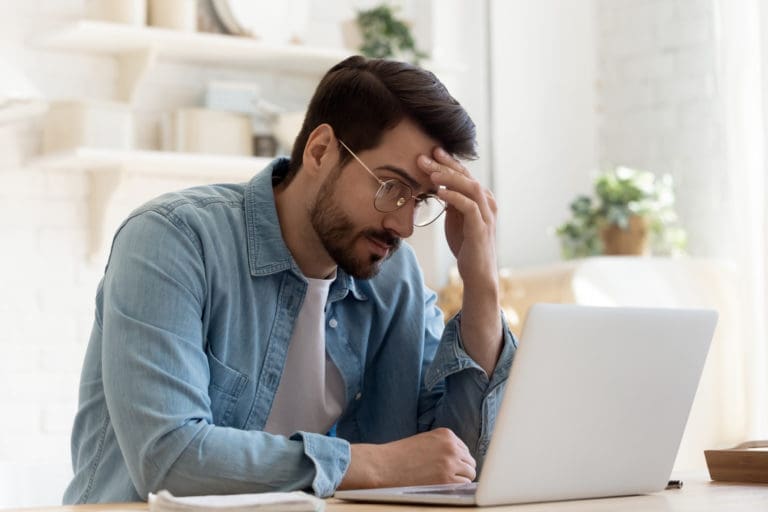 Man looking frustrated at his computer
